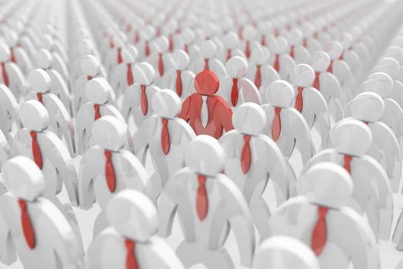 One orange figurine standing out from a crowd of white figurines, representing the difference between a comprehensive fee-only wealth advisor and a traditional stockbroker.